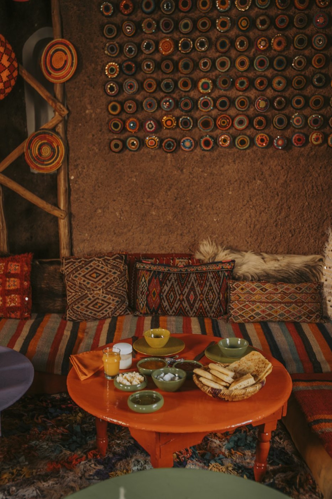Breakfast table set against a decorated wall